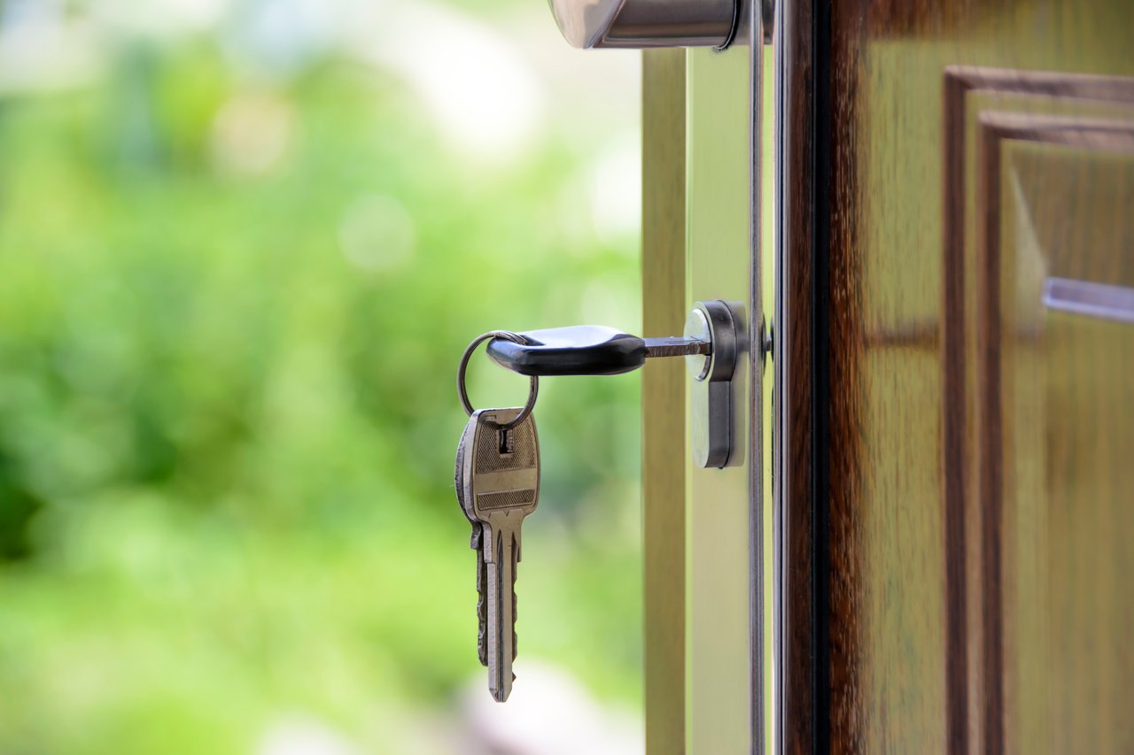 Keys in the door of a house, representing a newly purchased home